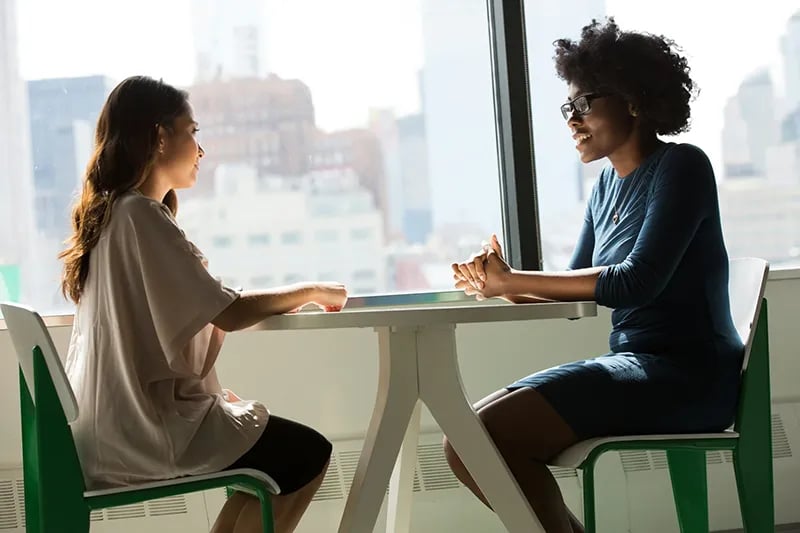 Women talking at a table