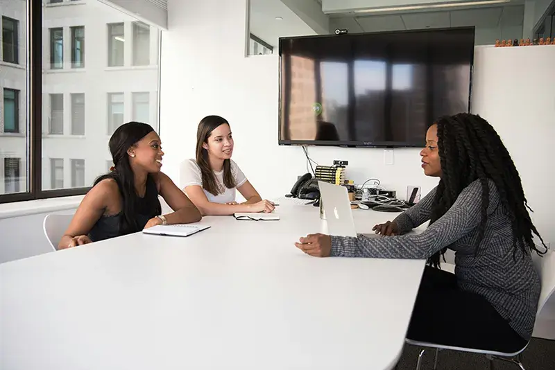 Three women on an office having a discussion